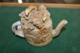 A novelty carved teapot.