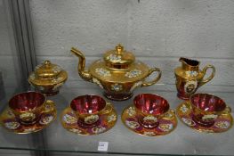 A continental gilt decorated ruby glass tea service.