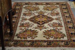 An unusual Persian carpet, cream ground with stylized floral decoration.