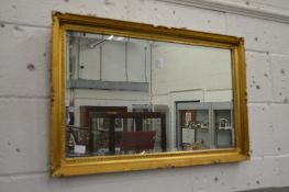 A gilt framed mirror.