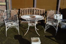 A white painted wirework circular garden table and pair of armchairs.