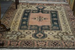 A Persian design carpet, cream and green ground with stylized decoration.