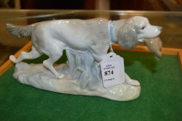 An unusual Lladro model of a retriever with a bird in its mouth.