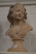 A plaster bust of a young girl.