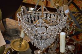 A brass and cut glass bag chandelier.