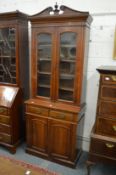 A Victorian walnut cupboard bookcase.
