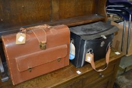 A bag of old camera equipment and binoculars together with a doctor's case.