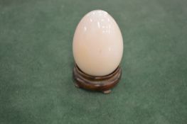 A model of an egg on stand.