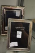A silver photograph frame and another frame.