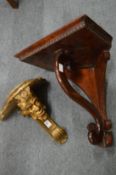 A carved and gilded wall bracket and a mahogany corner bracket.