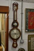 A mahogany cased barometer and thermometer.