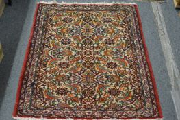 A small Persian rug with floral decoration.