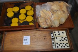 A set of ebony and bone dominoes, a bag of counters and a box containing draught counters.