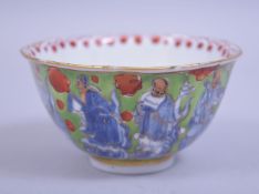 A CHINESE KANGXI PERIOD UNDERGLAZE BLUE AND ENAMEL IMMORTAL TEA BOWL, underglaze blue immortals with