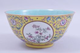 A CHINESE YELLOW GROUND FAMILLE ROSE PORCELAIN BOWL, decorated with circular panels of native