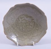 A CHINESE SONG STYLE OIL GLAZED DISH WITH CARVED LOTUS, further decorated with fish and foliate
