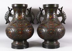 A PAIR OF JAPANESE CHAMPLEVE BRONZE CLOISONNE TWIN HANDLE VASES, the body decorated with enamelled