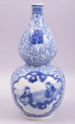 A CHINESE BLUE AND WHITE GOURD SHAPE PORCELAIN VASE, painted with two panels of figures and large