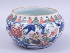 A CHINESE PORCELAIN DOUCAI BOWL, decorated with large flower heads and lion dogs, 17cm diameter.