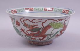 A CHINESE FAMILLE VERTE AND IRON RED PORCELAIN BOWL, the exterior painted with dragons and flora,