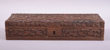 A 19TH CENTURY INDIAN RECTANGULAR CARVED WOOD BOX, carved with temples and animals amongst foliate