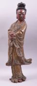 A CHINESE CARVED WOOD LACQUERED STANDING FIGURE OF GUANYIN, 57cm high.