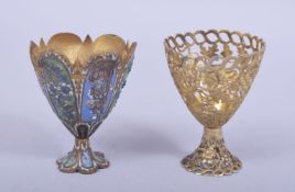 TWO 19TH CENTURY TURKISH OTTOMAN GILT METAL ZARF CUPS, one enamelled and one of openwork design,