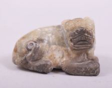 A CHINESE CARVED HARDSTONE FIGURE OF A LION DOG, 6cm long.