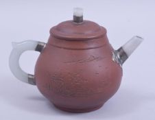 A CHINESE YIXING TEAPOT, with mounted celadon jade handle and spout, the side with incised