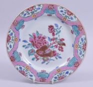 A CHINESE FAMILLE ROSE PORCELAIN DISH, the centre painted with a spray of native flora, 22.5cm