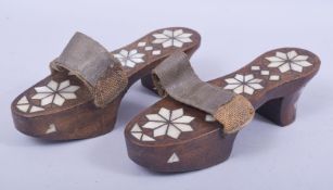 A PAIR OF TURKISH ABALONE OR MOTHER OF PEARL WOODEN SHOES, 23cm long. 670.
