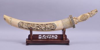 A CHINESE LATE 19TH / EARLY 20TH CENTURY CARVED AND STAINED IVORY DAGGER, carved in relief with