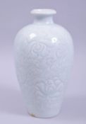 A CHINESE CELADON GLAZE POTTERY VASE, with incised floral decoration to the body, 22cm high.