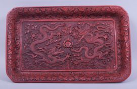 A 19TH/20TH CHINESE CINNABAR LACQUER RECTANGULAR TRAY, the centre with a panel of two dragons and