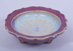 A CHINESE JUN WARE PETAL FORM DISH, the centre with a circular band of incised calligraphy, the dish