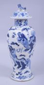 A 19TH CENTURY CHINESE BLUE AND WHITE PORCELAIN VASE AND COVER, decorated with kylin amongst