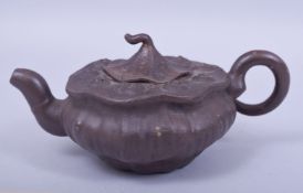 A CHINESE YIXING NATURALISTIC FORM TEAPOT AND COVER, with impressed mark to inner lid and base, 18cm