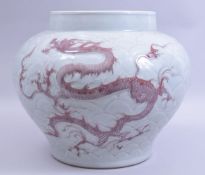 A LARGE CHINESE MING STYLE CELADON GLAZED AND COPPER RED DRAGON VASE, the body carved with scale