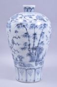 A CHINESE MING STYLE BLUE AND WHITE MEIPIN VASE, decorated with bamboo and plum blossom, 34cm high.