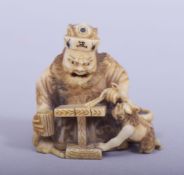 A JAPANESE MEIJI PERIOD CARVED IVORY NETSUKE - SHOKI AND ONI, shoki seated at his table aside an