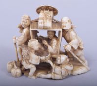 A JAPANESE MEIJI PERIOD CARVED IVORY OKIMONO, depicting two figure carrying a rickshaw with four