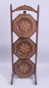 AN ANGLO INDIAN BONE OR IVORY INLAID THREE TIER FOLDING CAKE STAND, 79cm high.