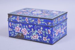 A 19TH CENTURY CHINESE CANTON ENAMEL LIDDED BOX, with a blue ground and floral decoration, 15cm