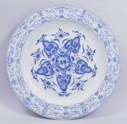 A VERY LARGE CHINESE BLUE AND WHITE PORCELAIN DISH, the centre painted with a stylised floral motif,