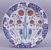 A LARGE TURKISH IZNIK POTTERY PLATE, with stylised flower heads and other decorative motifs, 30.