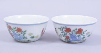 A PAIR OF CHINESE PORCELAIN CHICKEN CUPS, each base with six character mark, 8cm diameter.