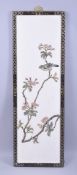 A CHINESE HARDSTONE OVERLAID PANEL, depicting a bird and native flora, 91cm x 30cm.