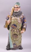 A JAPANESE KUTANI PORCELAIN FIGURE OF A WARRIOR holding a sword in his hand, 42cm high.