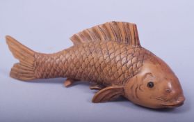 A LARGE JAPANESE CARVED WOOD MODEL OF A CARP, signed underside, 16.5cm long.
