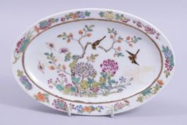 A SMALL CHINESE OVAL SHAPE DISH, painted with birds and native flora, the underside with six